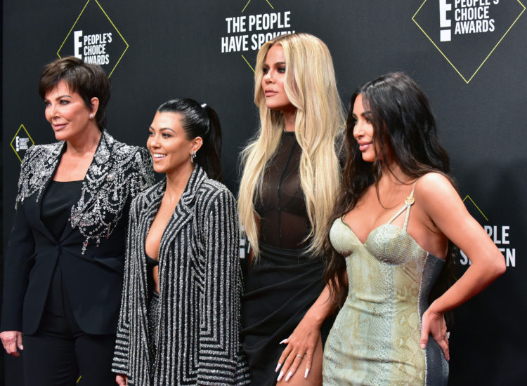 The Kardashians have gone from red carpet struts to rolling on shop rugs