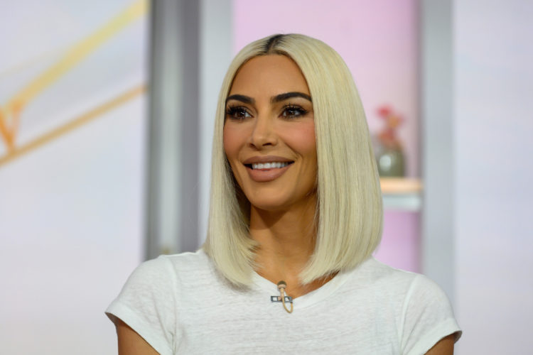 Kim makes 'beautiful' waves by going natural for SKKN oil drop pictures
