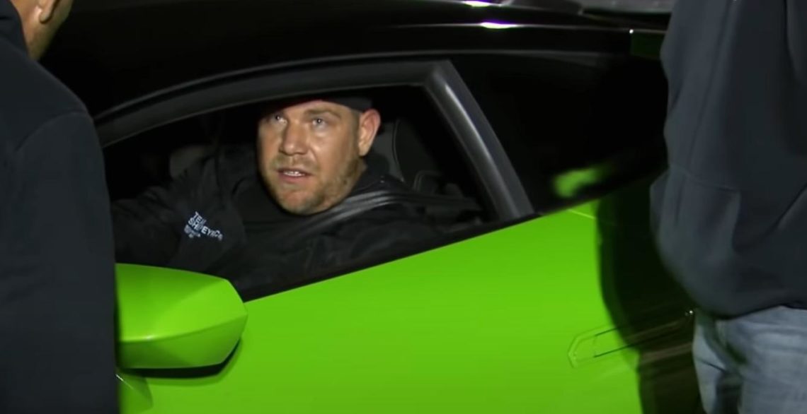 Ryan Fellows in car window of green Lamborghini.