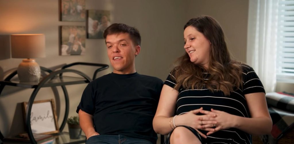 Zach Roloff speaks to camera while Tori, right, looks at him laughing.