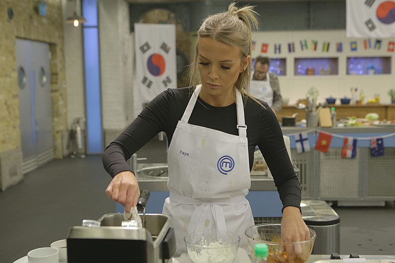 Faye Winter wears MasterChef apron while cooking on Celebrity MasterChef.