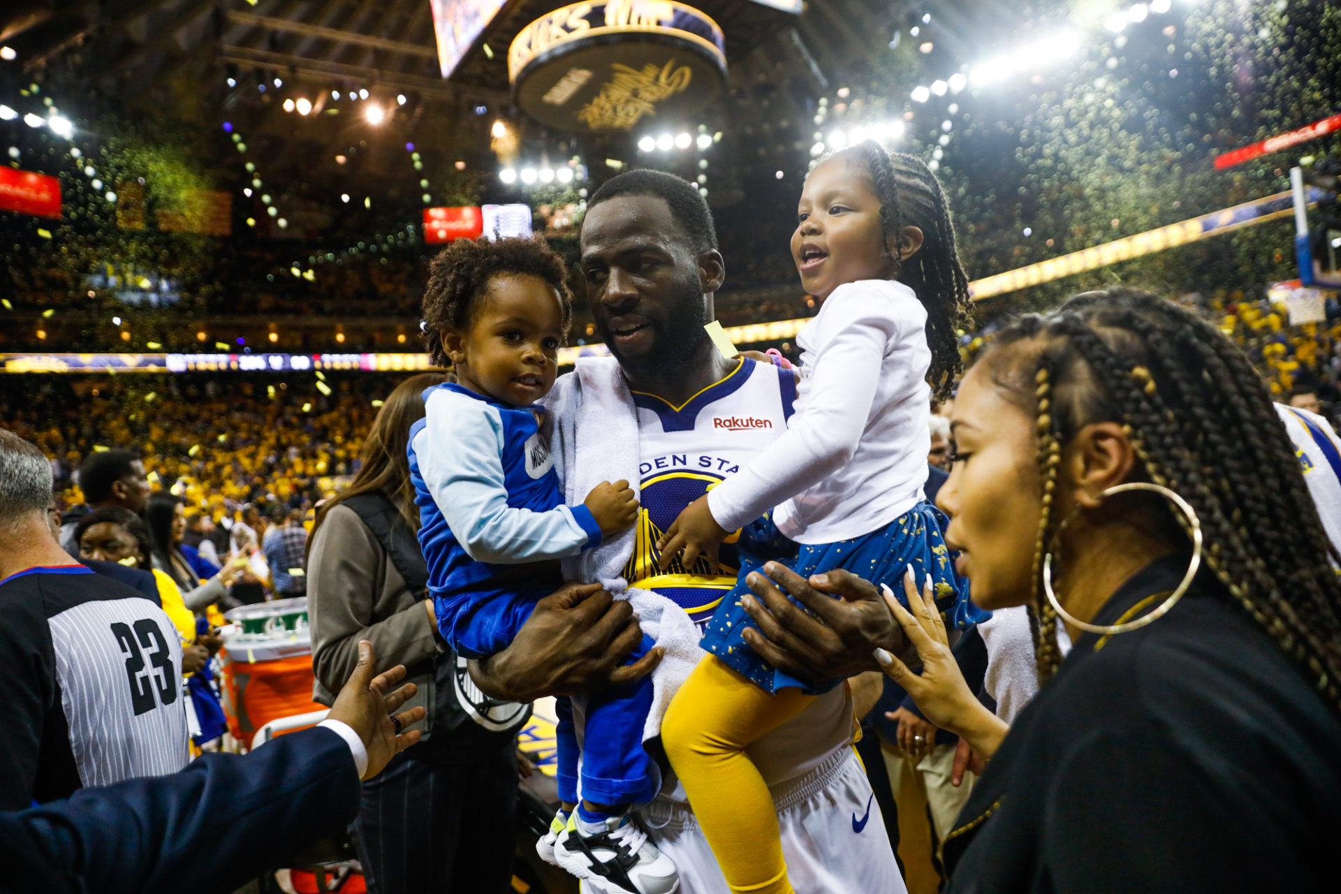 Draymond Green carries his son Dramond Green Jr. (left) and step-daughter Olive Pullen as he leaves the stadium with girlfriend Hazel Renee (right)  following the Warriors win of Game 5 of the Western Conference Semifinals between the Golden State Warrior
