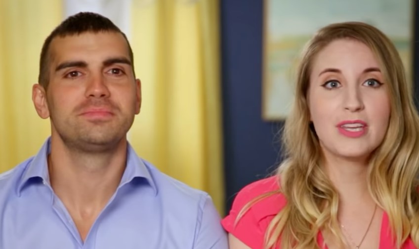 Aleksandr 'Sasha' Larin and Emily Larin look at the camera in 90 Day Fiancé interview