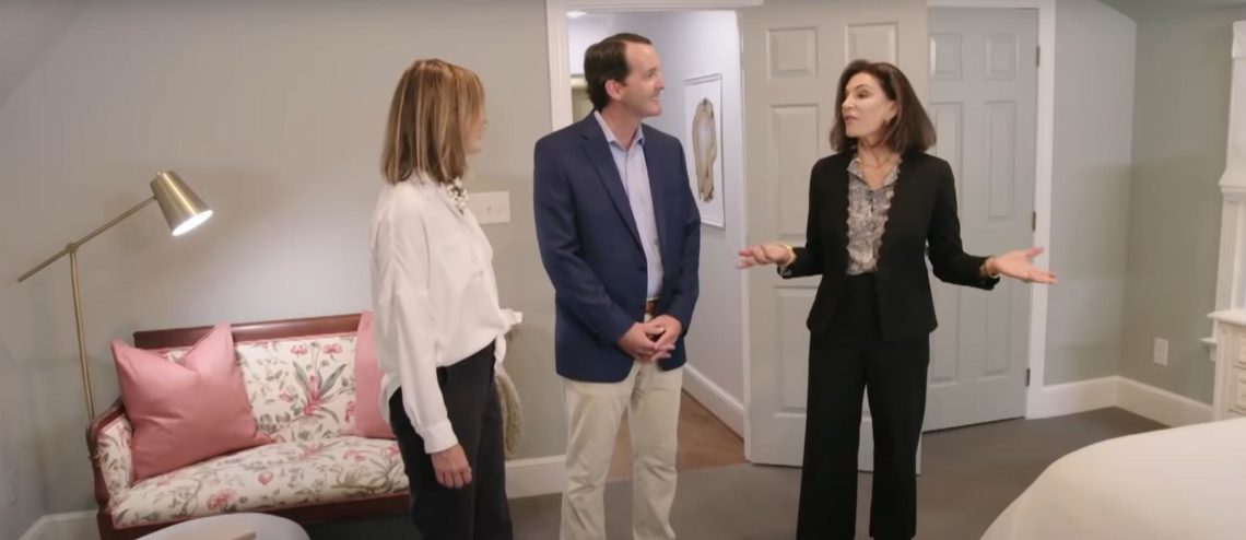 Hilary Farr (right) holds hand out while showing Love It or List It clients master bedroom.
