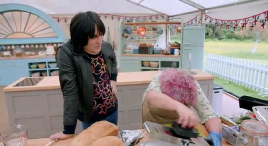 Noel Fielding (left) with Bake Off's Carole who bends her face down while prepping.