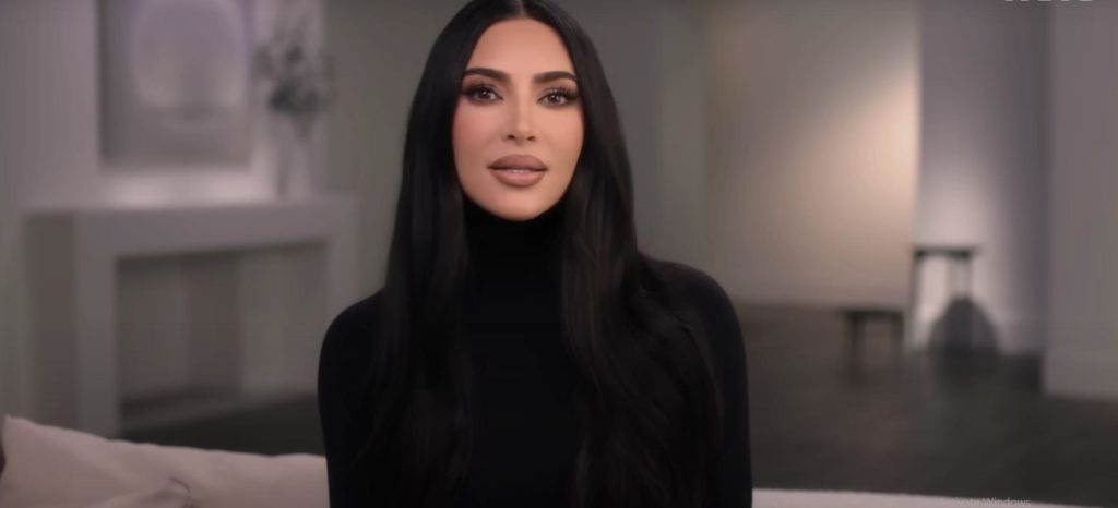 Kim Kardashian wears a black turtle neck sweater speaking in The Kardashians season 2 trailer