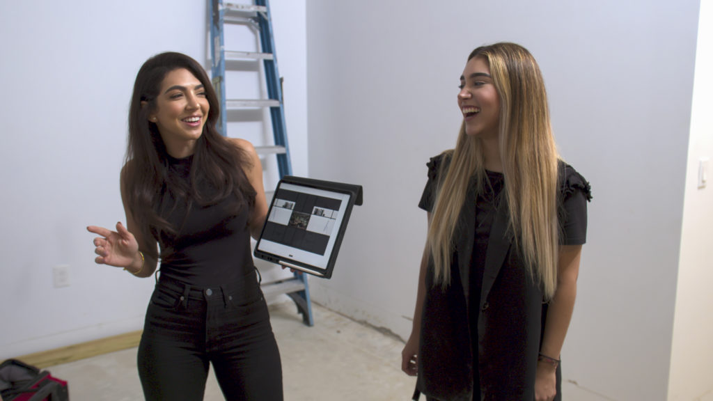 Eilyn Jimenez and Valentina are laughing while standing in model home