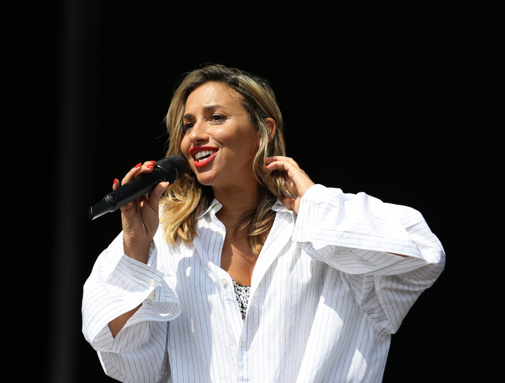 Mel Blatt holds microphone to her mouth at Victorious Festival 2019