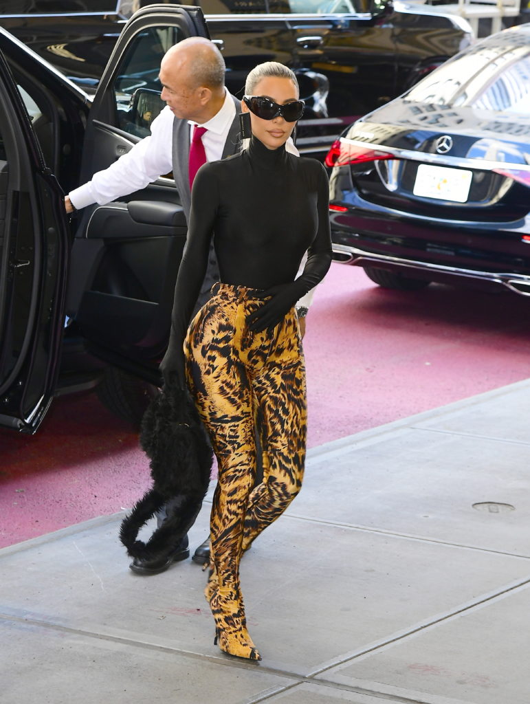 Kim Kardashian kicks her trolls to the curb in thigh-high Stuart ...