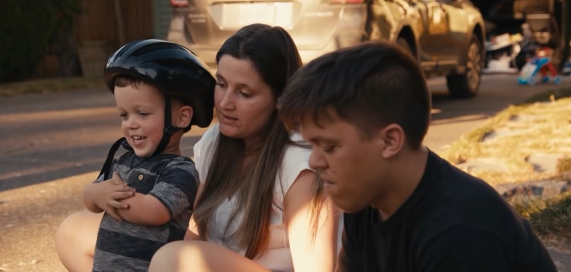 Jackson sits with his parents Zach and Tori Roloff on Little People, Big World wearing a helmet after skateboarding