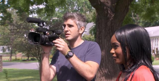 Max Joseph hold camera to his eye on Catfish as Trina stands by his side, both looking out of shot