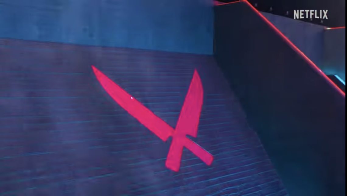Red Chef Knife Logo photographed on black studio background
