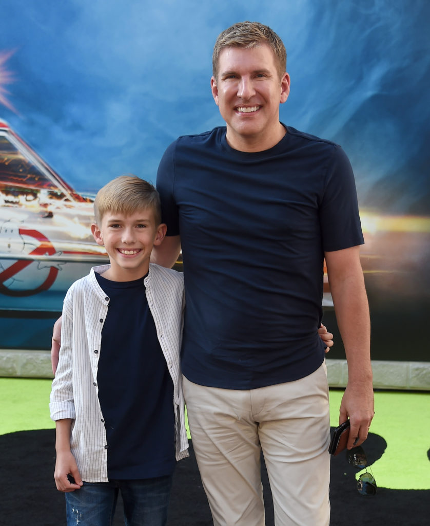 Todd and Grayson Chrisley stand together for a photo at the Premiere Of Sony Pictures' "Ghostbusters"