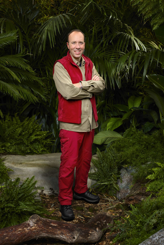 Matt Hancock poses for I'm A Celebrity 2022 promo photo wearing campmate clothing with his arms crossed