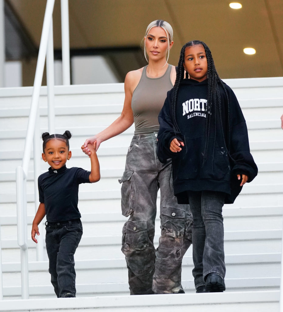 Kim Kardashian holds daughter Chicago's hand as they walk down steps with North West