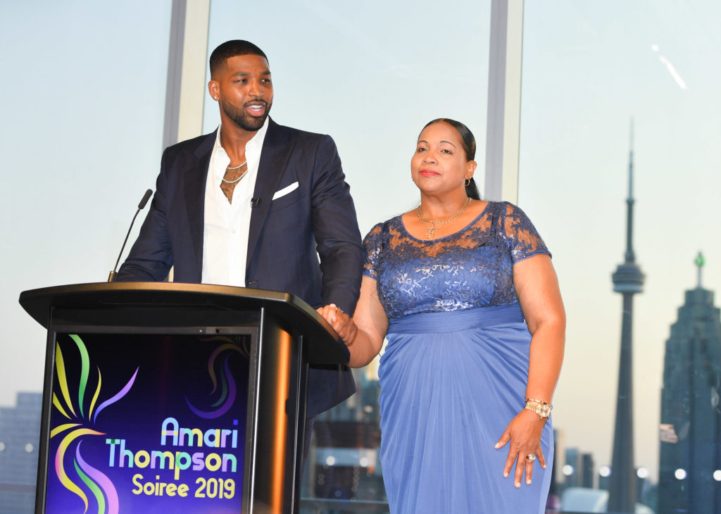 Tristan Thompson and his mother stand at a microphone together at The Amari Thompson Soiree 2019