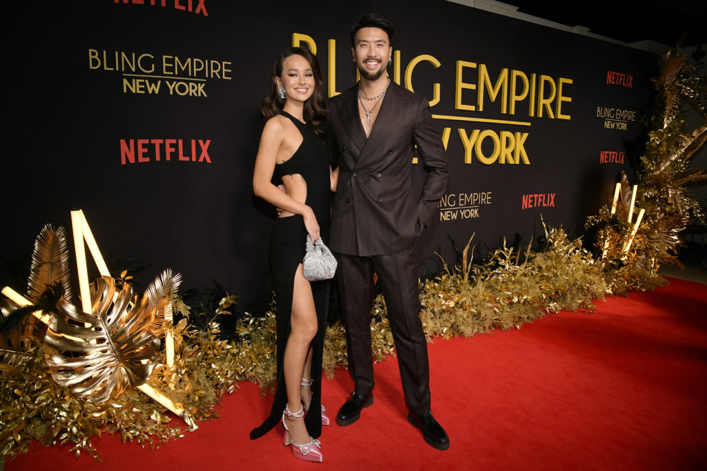 Richard Chang and Vika Abbyaeva attend the "Bling Empire New York" Launch Celebration wearing evening wear as they pose together smiling