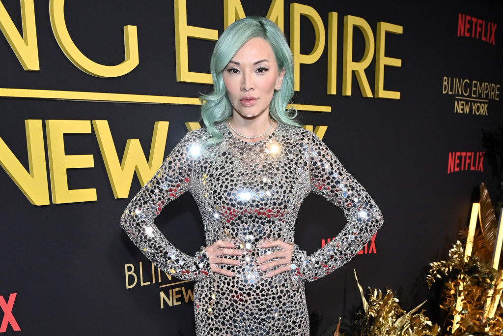 Tina Leung poses wearing silver dress with her hands on her hips and blue hair