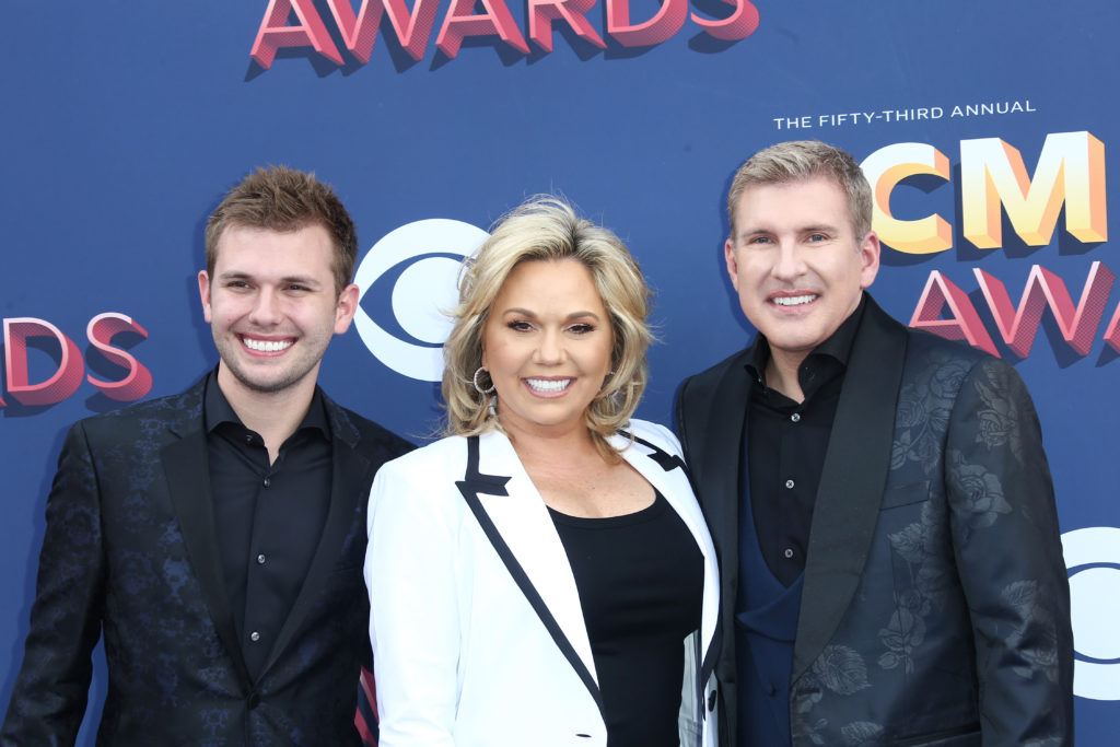 Chase Chrisley, Julie Chrisley, and Todd Chrisley attend the 53rd Academy of Country Music Awards at MGM Grand Garden Arena wearing suit jackets