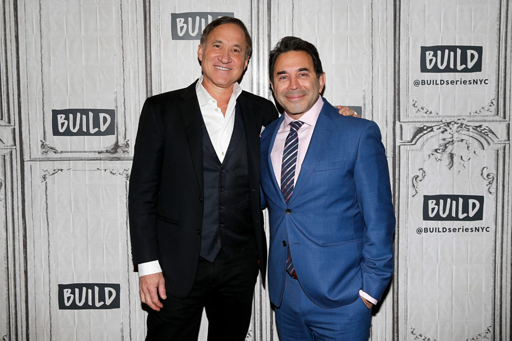 Terry Dubrow and Paul Nassif pose together wearing suits