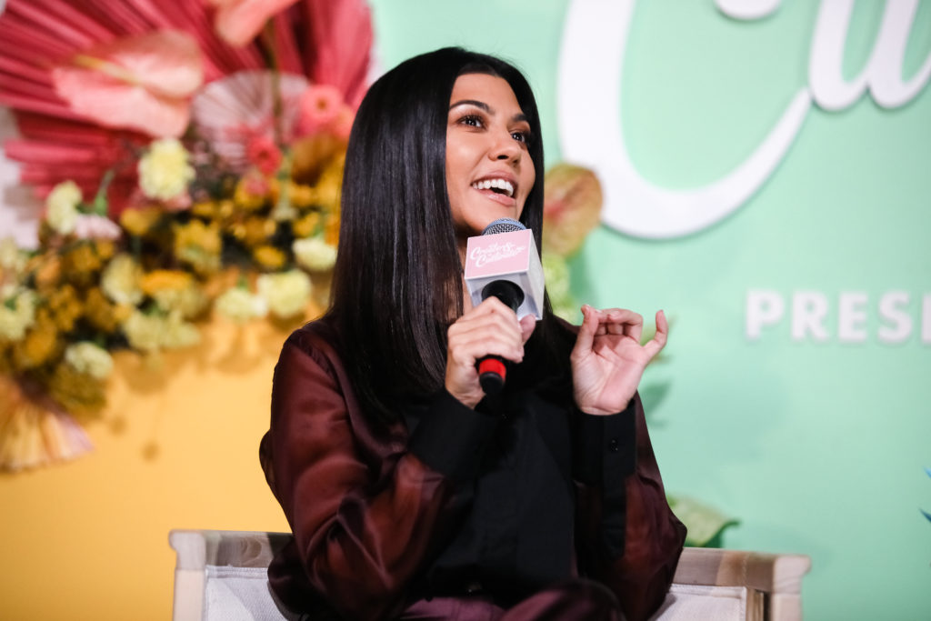 Kourtney Kardashian holds microphone to her mouth at Create And Cultivate Conference