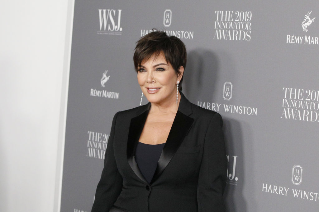 Kris Jenner poses on red carpet wearing black blazer and top