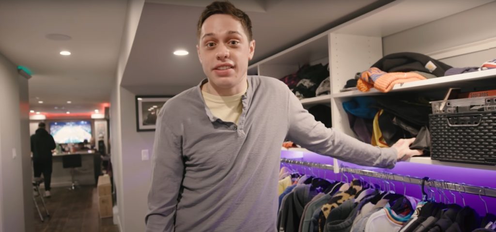 Pete Davidson standing in his closet in his basement apartment