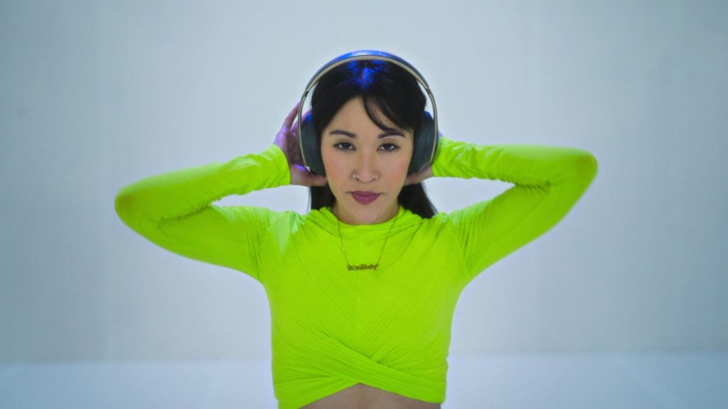 Brandi Chun poses with hands on her head on Dance 100