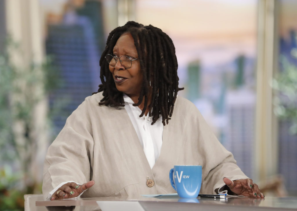 WHOOPI GOLDBERG sits at desk on The View wearing cream cardigan