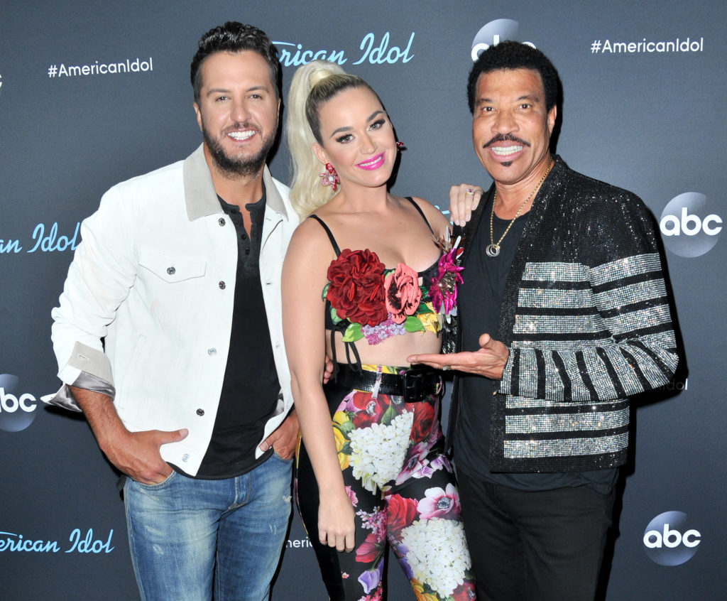 ABC's "American Idol" judges Luke Bryan, Katy Perry and Lionel Richie smile and pose together