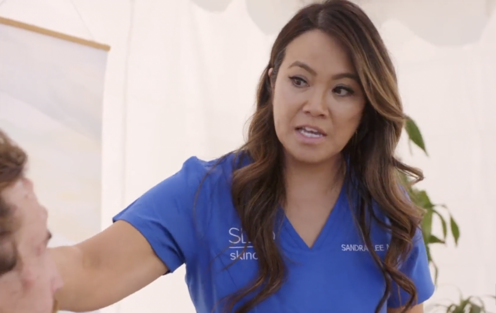 Dr Pimple Popper looking shocked at patients forehead