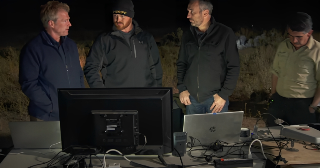 The Curse of Skinwalker Ranch cast standing by a table at night time for experiment