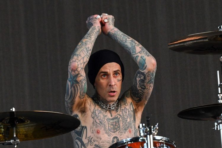 Travis Barker pouts with his 'twin' but fans struggle to see resemblance