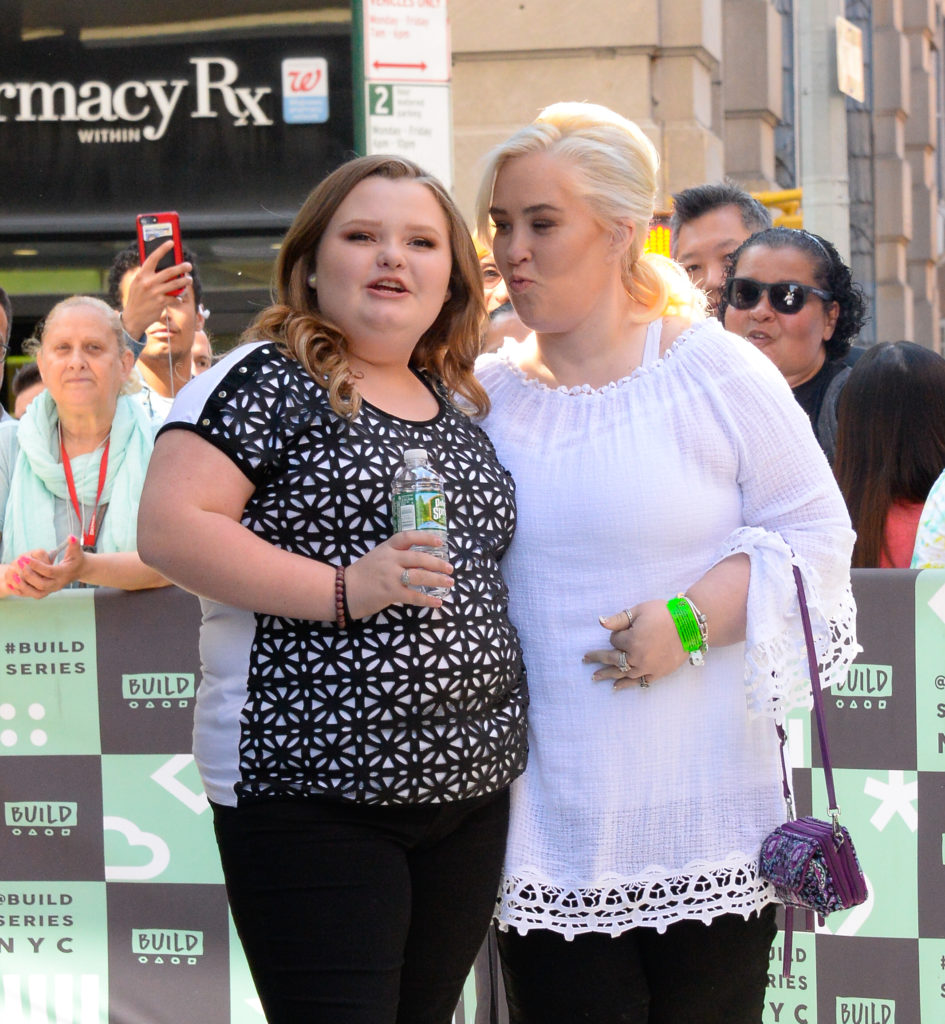 Mama June poses to kiss her daughter Honey Boo Boo on the cheek in New York as Alana looks across camera