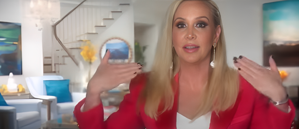 Shannon Beador speaks in confessional on RHOC wearing pink blazer, white top and long blond hair worn down