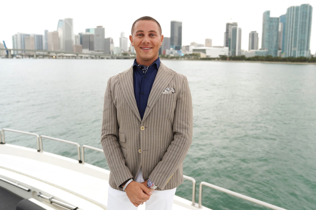Jack smiles for promo in suit jacket for Hot Yachts Miami cast shot