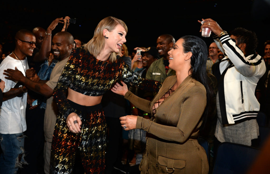 Kim Kardashian and Taylor Swift face each other smiling at the 2015 MTV Video Music Awards